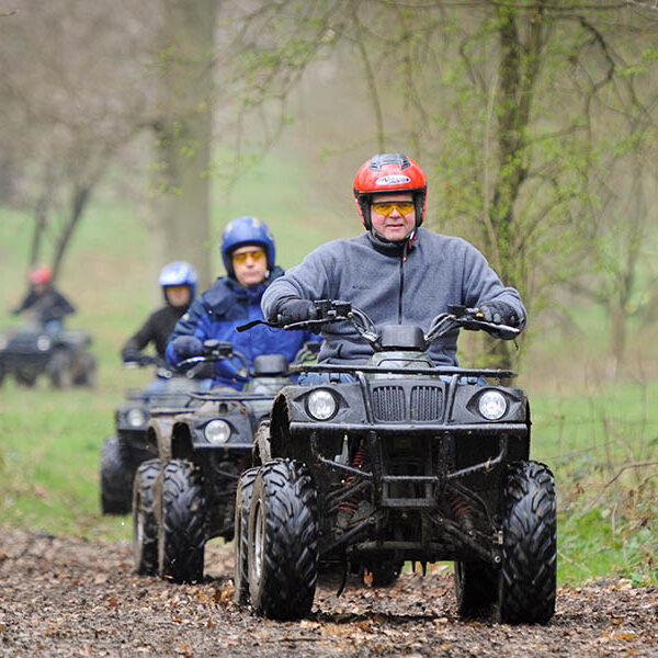 Students riding Quad bikes followed by instructor at Ashdown Farm, Kent