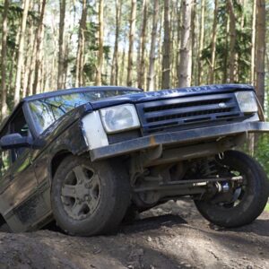 Landrover driving on bank in woodland