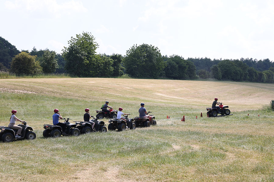 Group of riders on a quad adventure through 200 acres of open fields and orchards