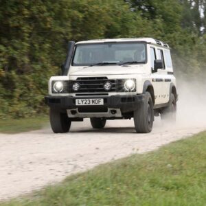 White Grenadier driving alone gravel road